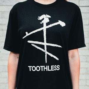 Black tee with white Toothless logo and text