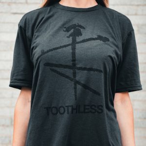 Grey tee with black Toothless logo and text